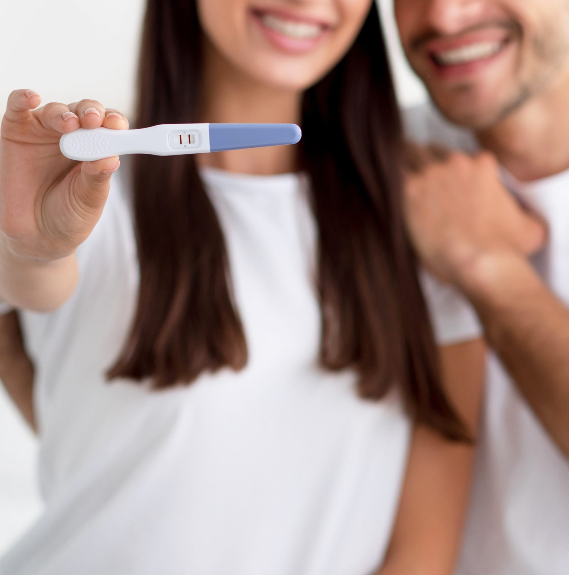 A couple seeing their positive pregnancy test result